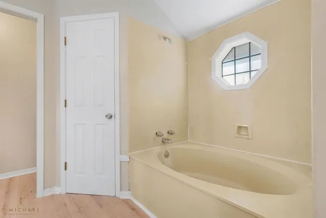 a white bath tub sitting next to a window