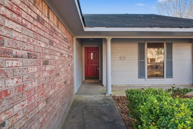 a view of brick house with a large window