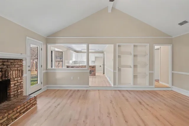 wooden floor in an empty room with a window
