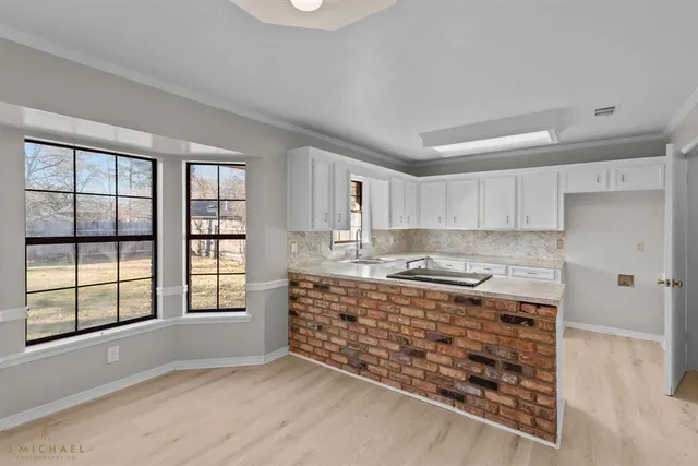 a large kitchen with a stove a sink and dishwasher