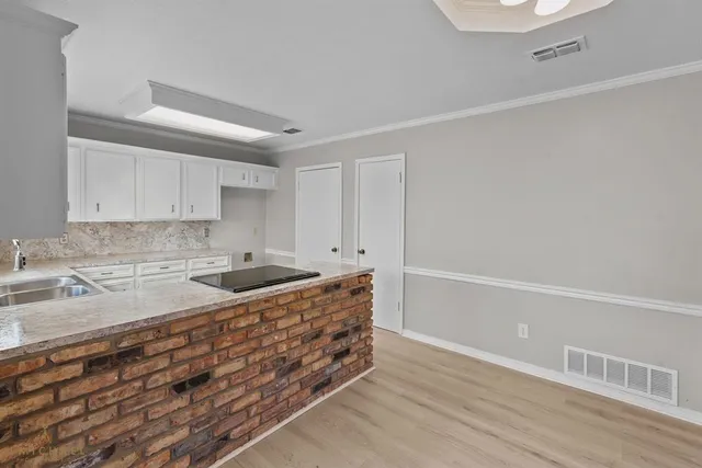 a kitchen with granite countertop a sink and cabinets