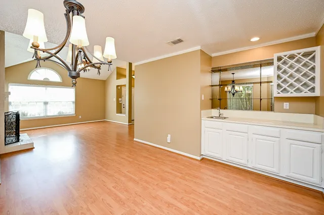 a view of a room with wooden floor and windows