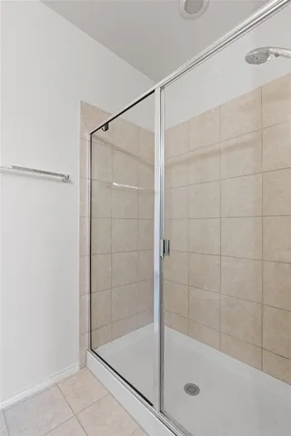 a bathroom with a glass shower door