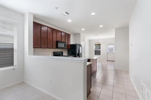 a kitchen with stainless steel appliances a refrigerator sink and cabinets