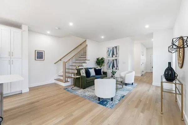 a view of a hallway with wooden floor and staircase