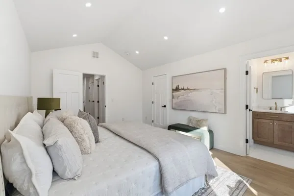 a bedroom with a bed and a window