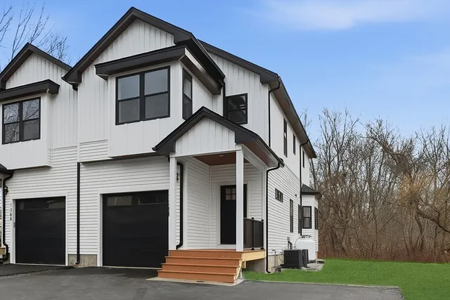 a kitchen with stainless steel appliances kitchen island a table and chairs in it