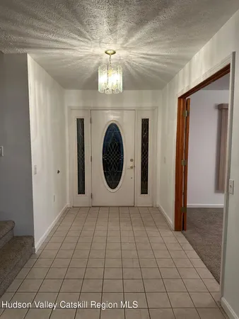 a view of a hallway with a chandelier