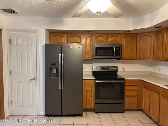 a kitchen with a refrigerator and a stove