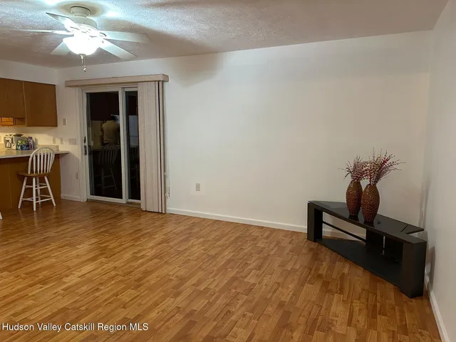 a view of a livingroom with furniture and a window