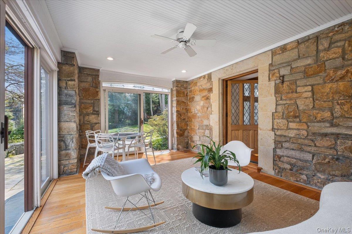66 Lockwood Road Scarsdale, NY 10583 - Photo 18 of 47 Sunroom with doors opening to a patio overlooking the pond