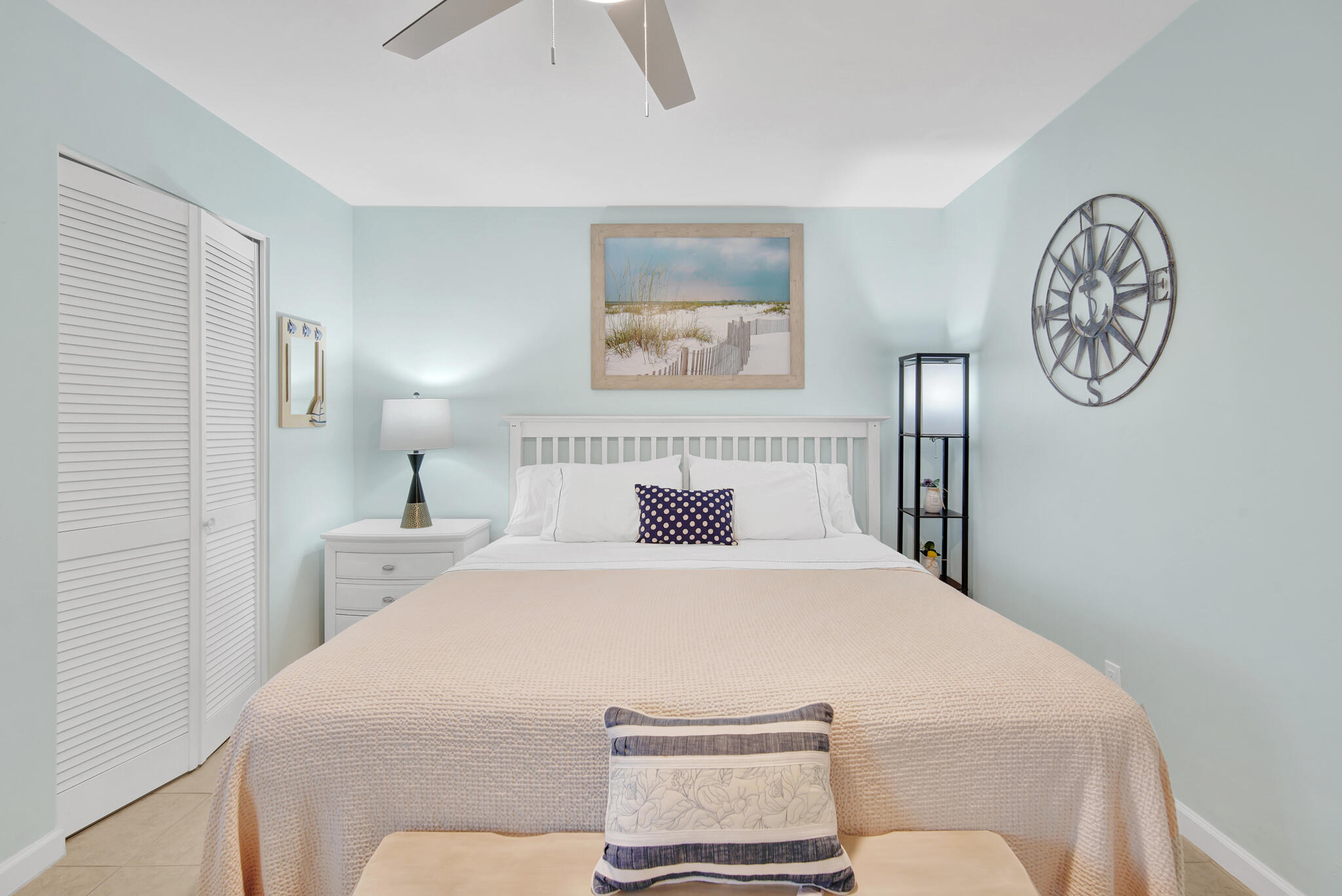 60 Sandprints Drive, Unit E7 Miramar Beach, FL 32550 - Photo 15 of 26 a bedroom with a bed and a lamp on dresser