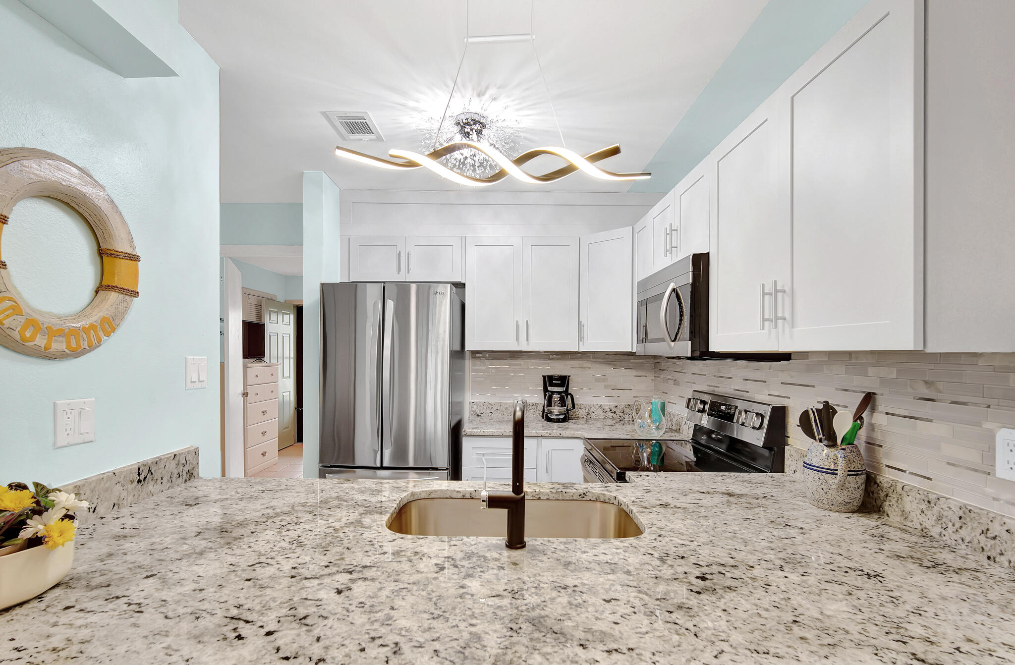 60 Sandprints Drive, Unit E7 Miramar Beach, FL 32550 - Photo 8 of 26 a kitchen with stainless steel appliances granite countertop a stove a sink a refrigerator and a microwave