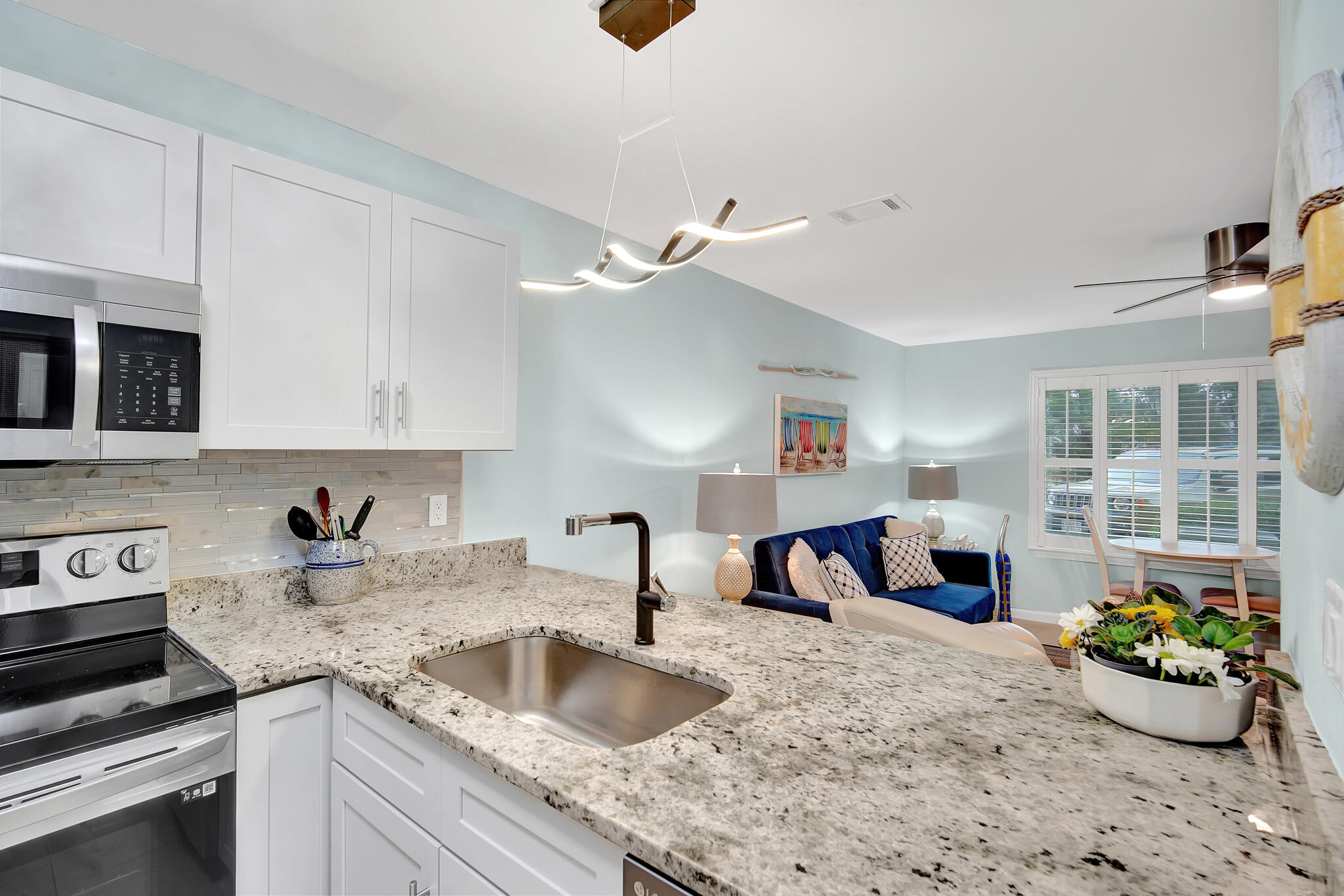 60 Sandprints Drive, Unit E7 Miramar Beach, FL 32550 - Photo 9 of 26 a kitchen with a sink and a stove top oven