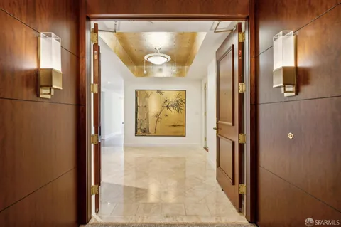 a view of empty room with wooden floor and fireplace