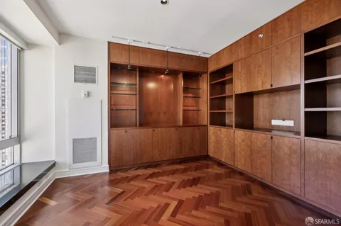 a view of a room with wooden floor