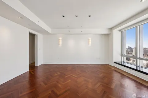 a view of a hallway to other room and wooden shelves