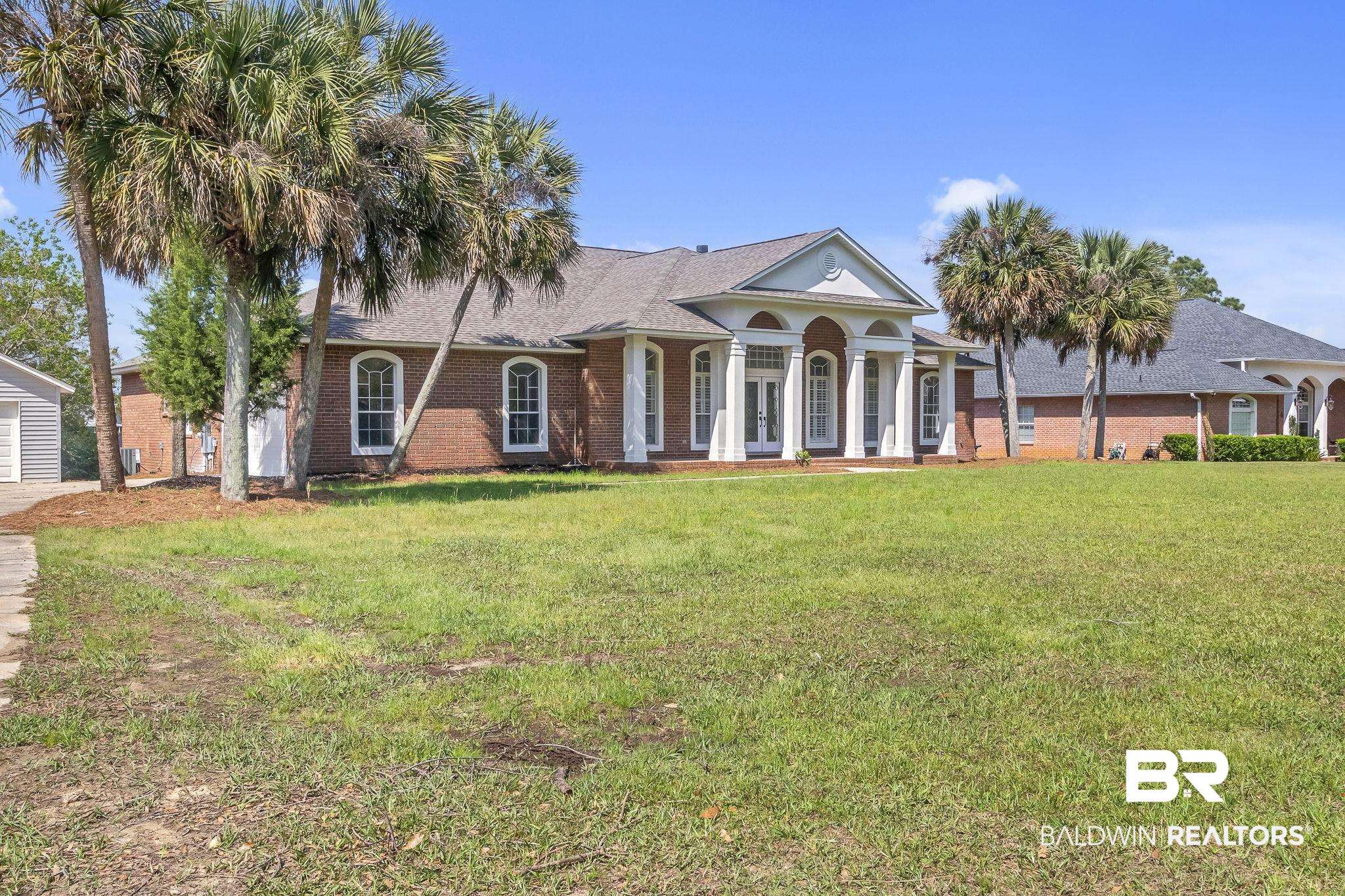20265 Erin Pond Road Seminole, AL 36574 - Photo 86 of 97 Greek revival house featuring french doors, brick siding, and a front lawn