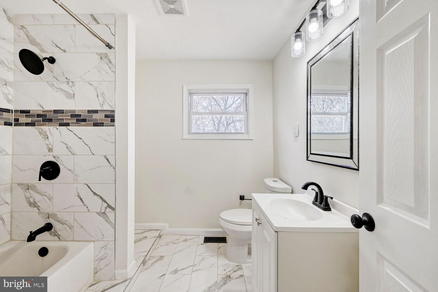207 South Rock Glen Road Baltimore, MD 21229 - Photo 11 of 28 Modern elegance in a serene bathroom.