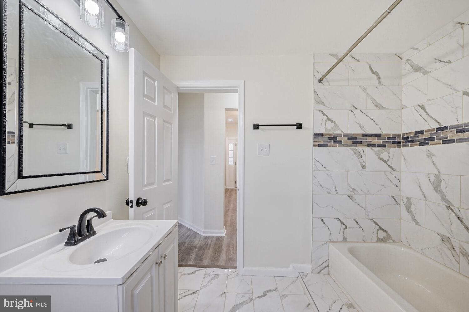 207 South Rock Glen Road Baltimore, MD 21229 - Photo 12 of 28 Modern elegance in a serene bathroom.