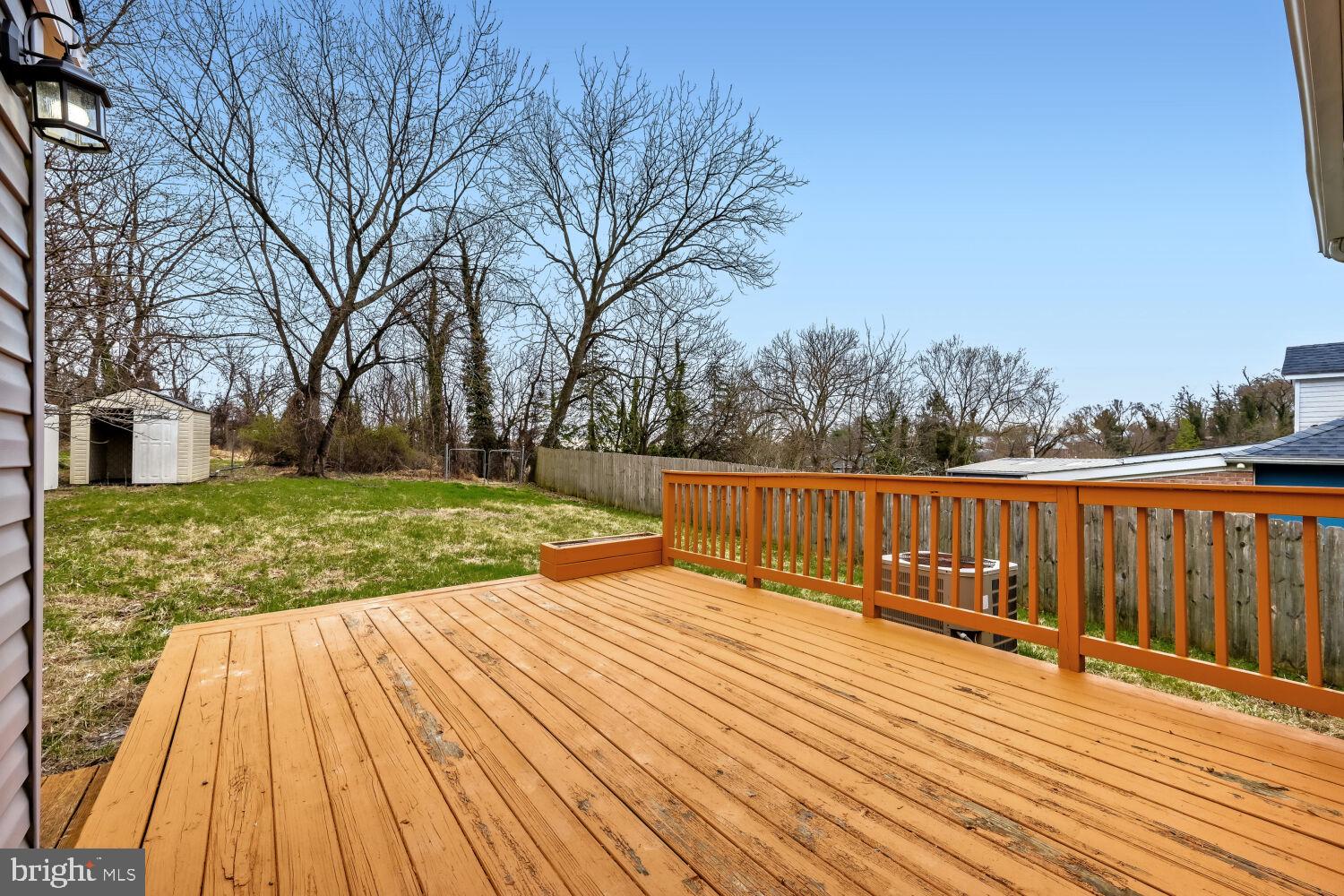 207 South Rock Glen Road Baltimore, MD 21229 - Photo 26 of 28 Spacious deck overlooking serene yard.