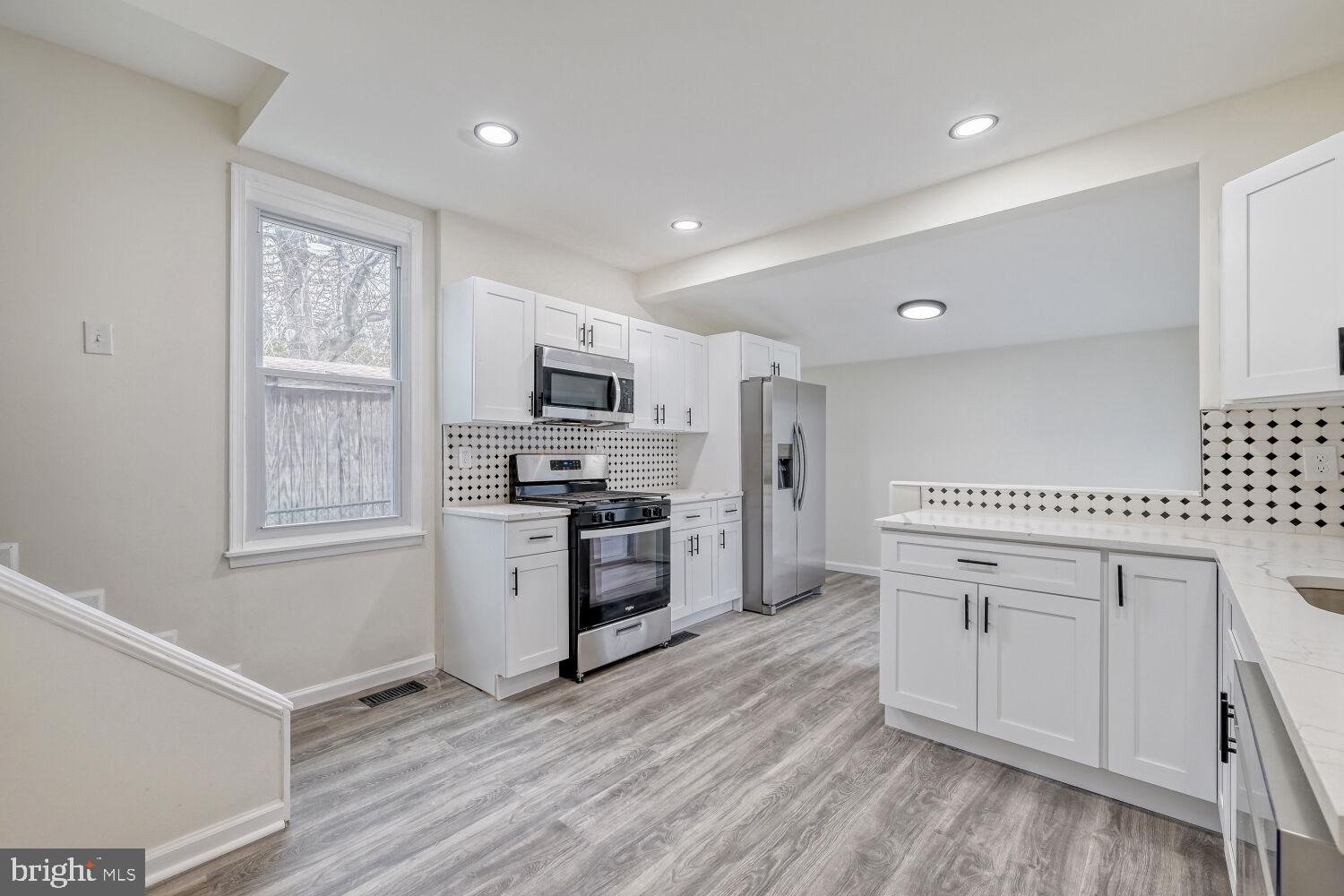 207 South Rock Glen Road Baltimore, MD 21229 - Photo 5 of 28 Modern kitchen with sleek finishes.