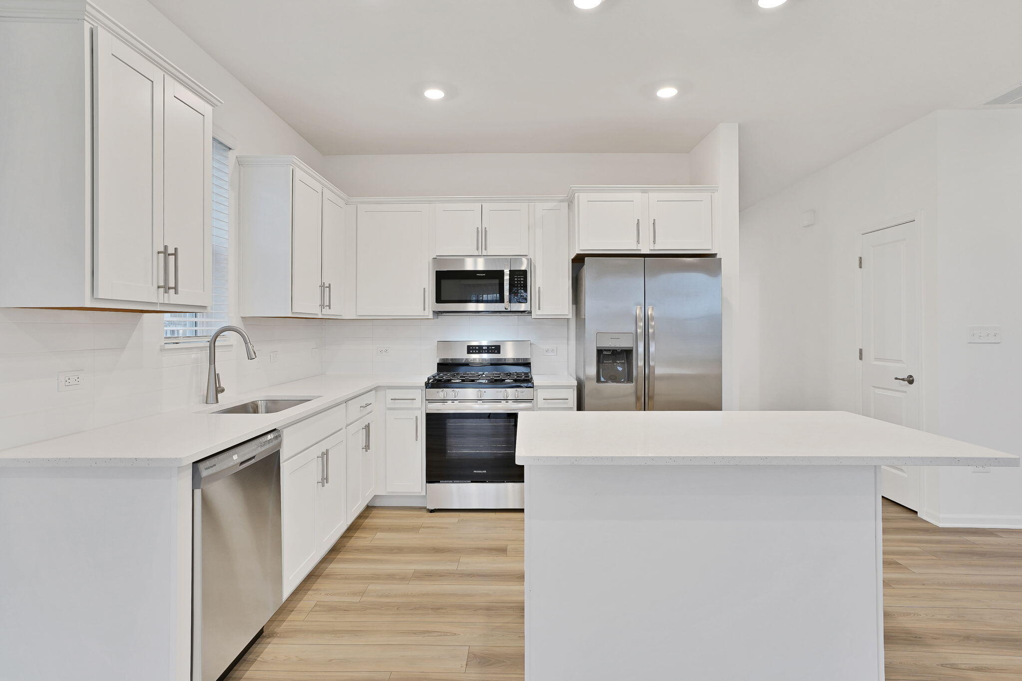 12541 Virginia Street Crown Point, IN 46307 - Photo 11 of 24 a kitchen with kitchen island granite countertop white cabinets and stainless steel appliances