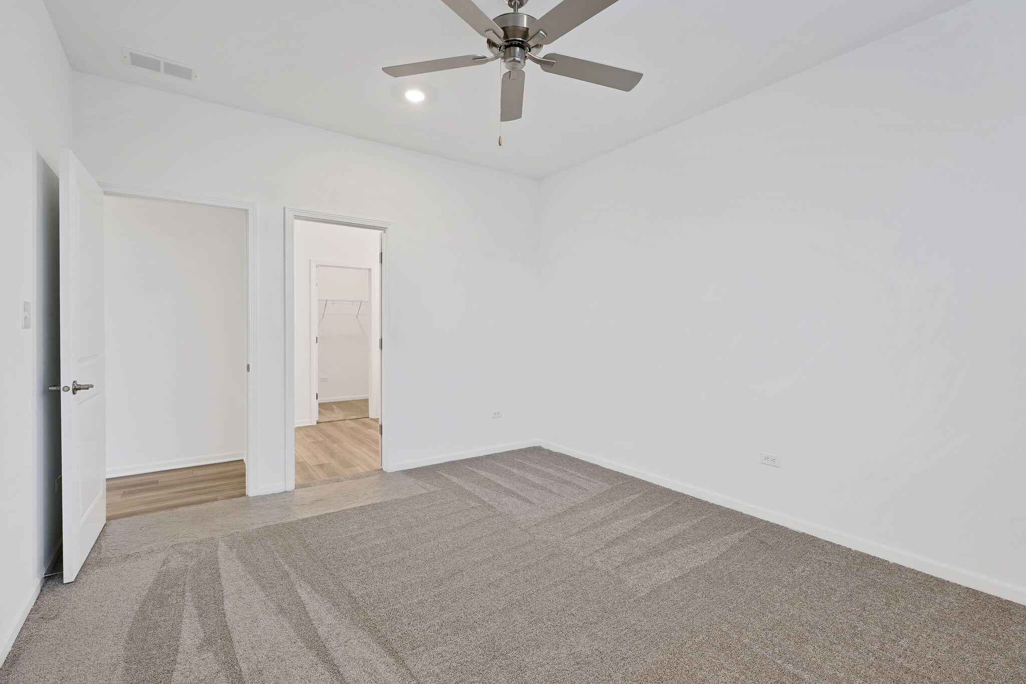 12541 Virginia Street Crown Point, IN 46307 - Photo 16 of 24 an empty room with a ceiling fan and carpet