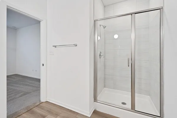 a bathroom with a glass shower door