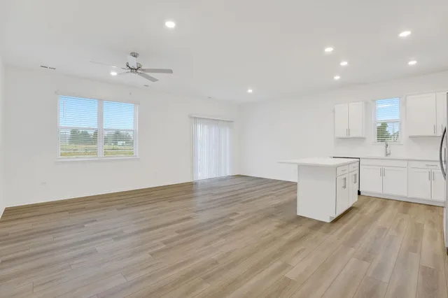 a view of kitchen with granite countertop cabinets and wooden floor