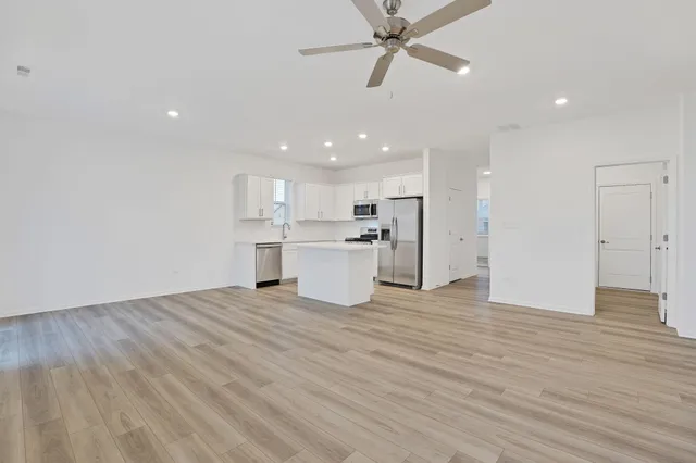 a view of a kitchen with a sink and wooden floor