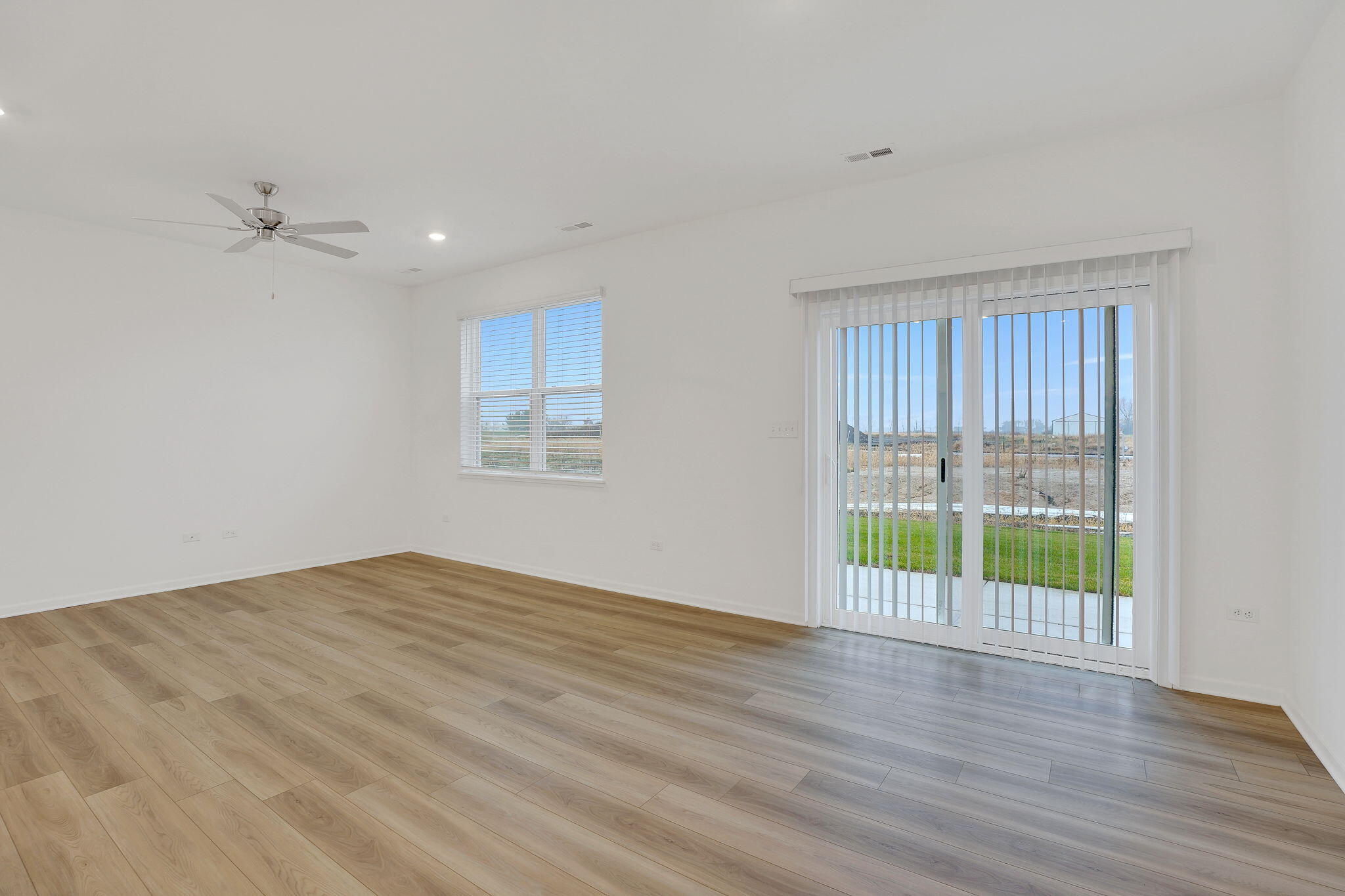12541 Virginia Street Crown Point, IN 46307 - Photo 9 of 24 a view of an empty room with wooden floor and a window