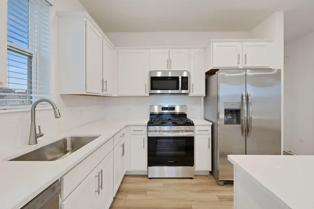 a kitchen with a sink stove and refrigerator