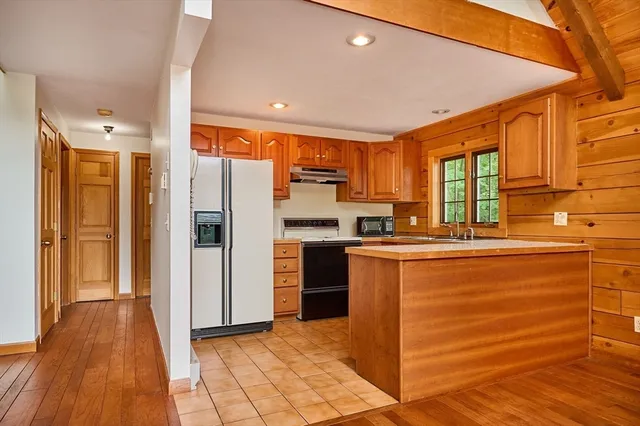 a view of a house with a wooden deck