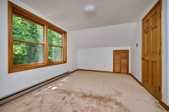 a bathroom with a sink a toilet a window and shower