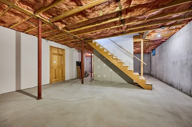 a view of backyard with wooden stairs and a large tree