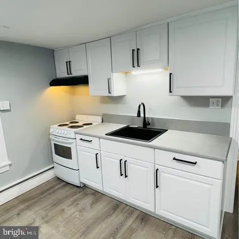a kitchen with white cabinets and white appliances