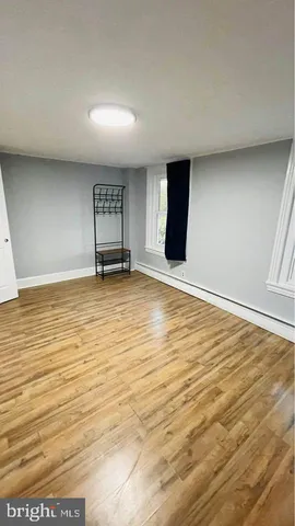 an empty room with wooden floor