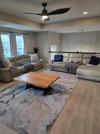 a bedroom with furniture and a ceiling fan