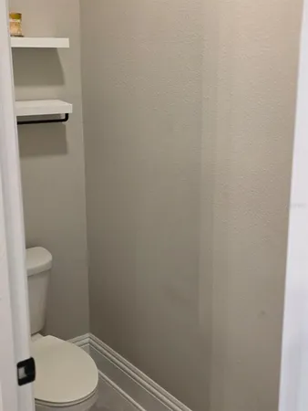 a white toilet sitting next to a shower