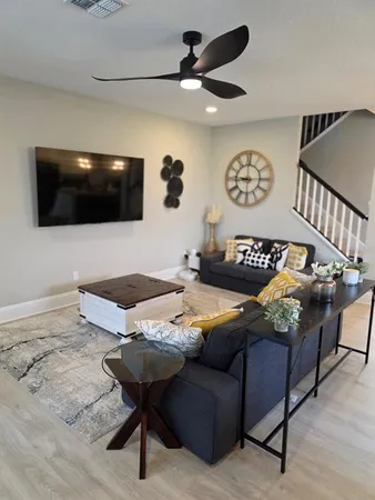 a living room with furniture and a flat screen tv