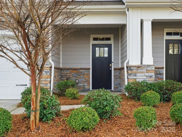 a front view of a house with garden