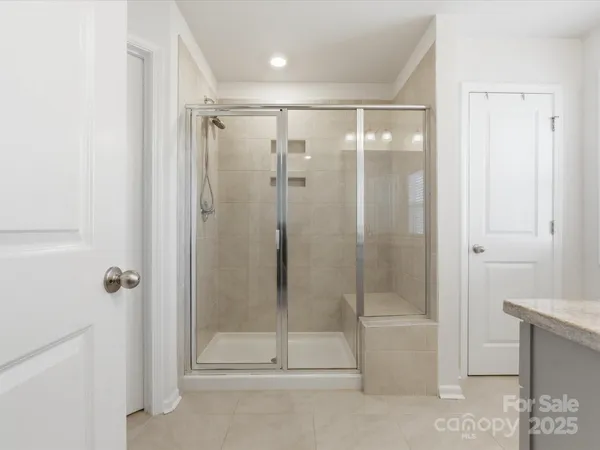 a bathroom with a glass shower door