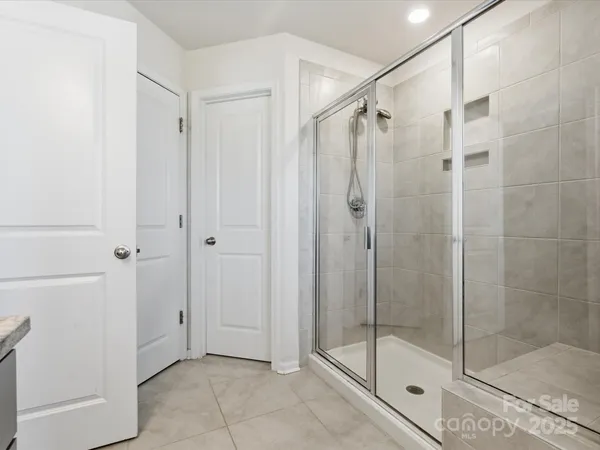 a bathroom that has a glass shower door