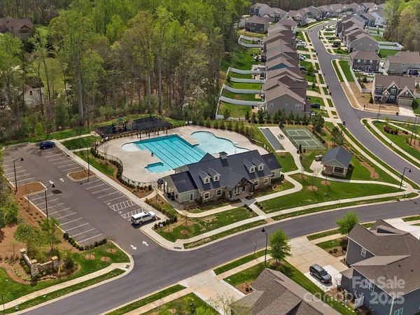 an aerial view of a tennis ground with large trees