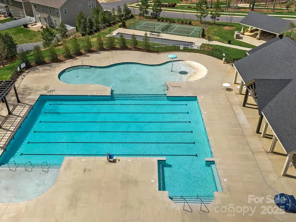 a view of a swimming pool with a yard