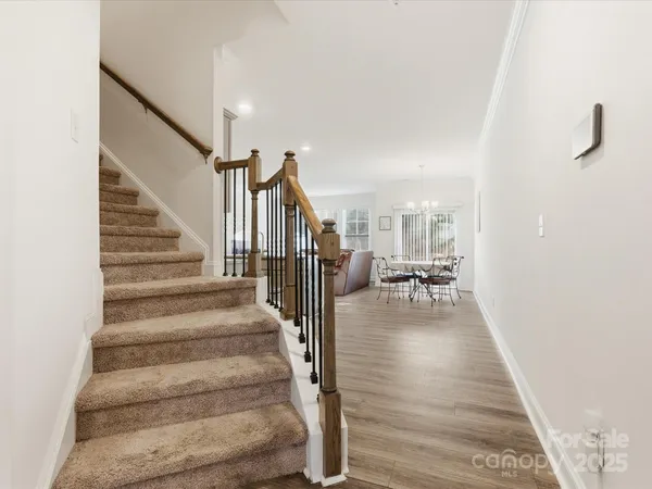 a view of entryway and hall with wooden floor