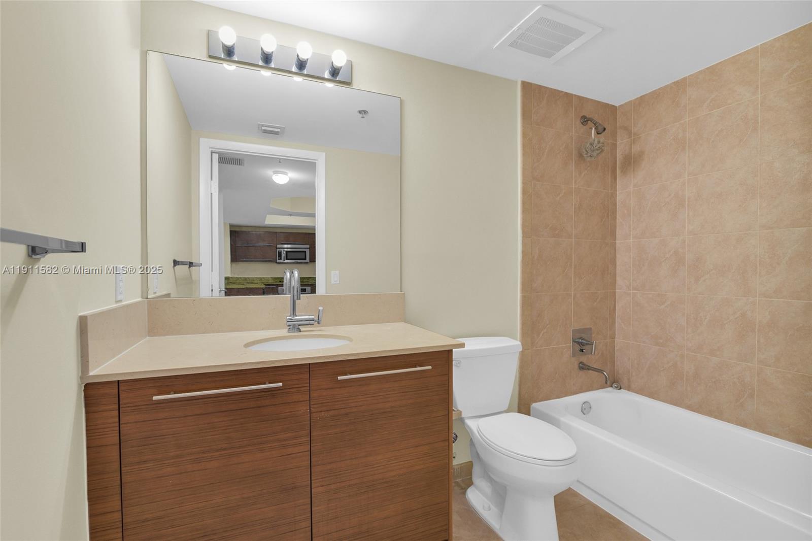 2681 North Flamingo Road, Unit 1903S Sunrise, FL 33323 - Photo 19 of 55 a bathroom with a sink toilet vanity and shower