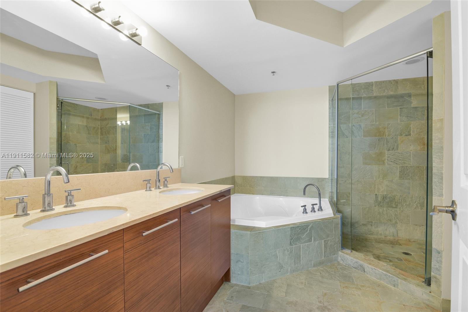 2681 North Flamingo Road, Unit 1903S Sunrise, FL 33323 - Photo 28 of 55 a bathroom with a sink a mirror and a bathtub