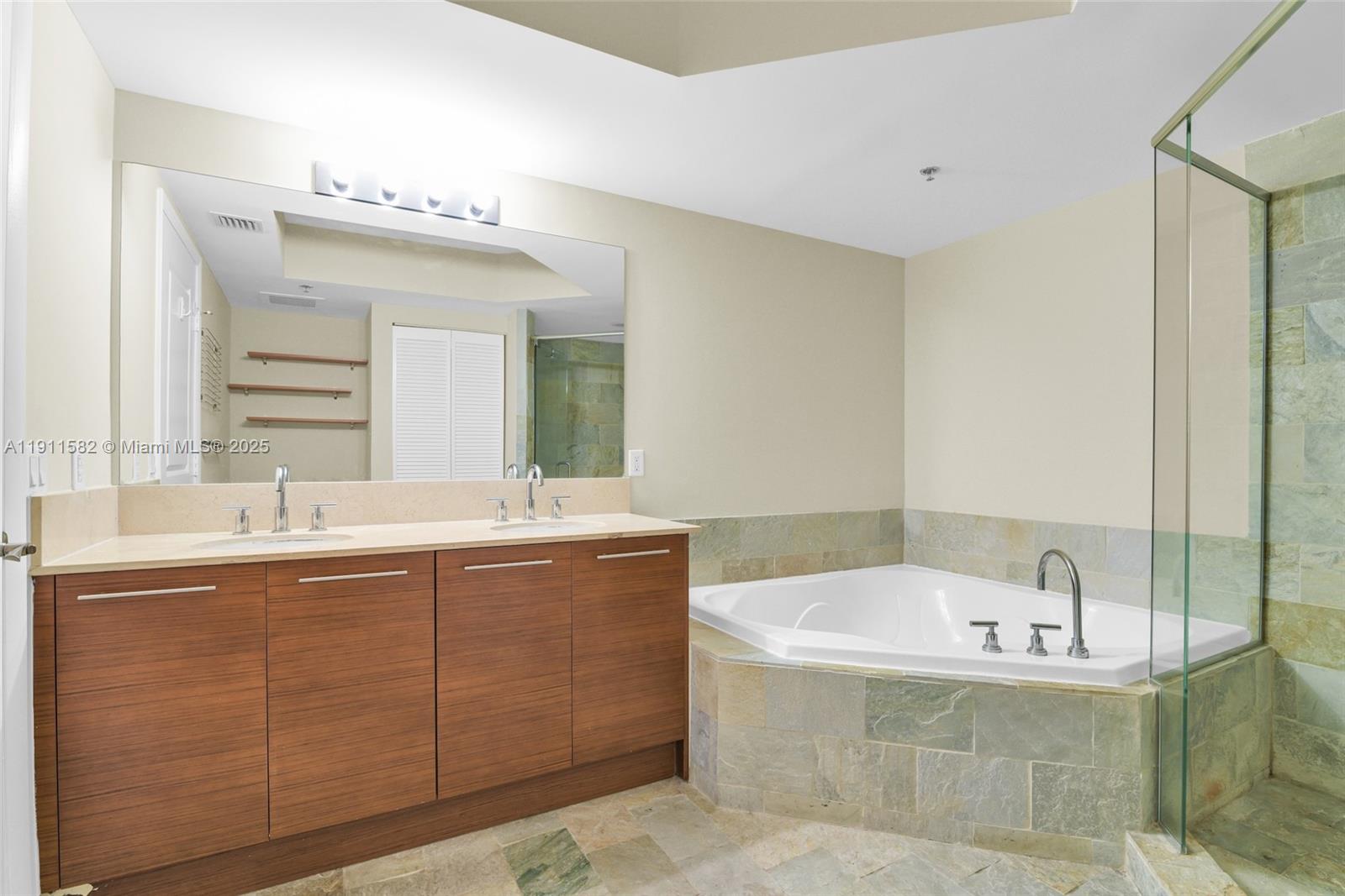 2681 North Flamingo Road, Unit 1903S Sunrise, FL 33323 - Photo 30 of 55 a bathroom with a tub sink and mirror